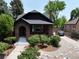 Attractive brick home with an arched entryway, white stairs, and neatly arranged landscaping in front at 2636 N Glencoe St, Denver, CO 80207