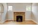 Classic fireplace with ornate tile and mantle with refinished hard wood floors and traditional archway at 2636 N Glencoe St, Denver, CO 80207