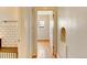 Hallway view into a bedroom with hardwood floors and multiple windows at 2636 N Glencoe St, Denver, CO 80207