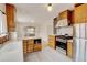 The kitchen features custom wood cabinets, modern stainless steel appliances, and an open view to the dining area at 2636 N Glencoe St, Denver, CO 80207