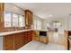 Bright kitchen features custom wooden cabinets, stainless steel appliances, a large sink, and sleek countertops at 2636 N Glencoe St, Denver, CO 80207