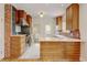 Well-lit kitchen featuring custom wooden cabinetry, stainless steel appliances, and bright countertops at 2636 N Glencoe St, Denver, CO 80207