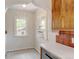 Bright kitchen featuring tile backsplash, custom cabinets, and archway leading into adjacent room at 2636 N Glencoe St, Denver, CO 80207
