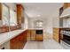 Bright kitchen features custom wooden cabinets, stainless steel appliances, and sleek countertops at 2636 N Glencoe St, Denver, CO 80207