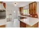 Modern kitchen with custom wooden cabinetry, sleek countertops, and an adjacent dining area at 2636 N Glencoe St, Denver, CO 80207