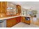 Kitchen featuring wood cabinets, stainless steel appliances, a breakfast bar and tile countertops at 2636 N Glencoe St, Denver, CO 80207