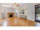 Living room with hardwood floors, a brick fireplace, a radiator and decorative front door at 2636 N Glencoe St, Denver, CO 80207