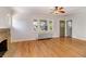 Living room featuring hardwood floors, a brick fireplace, radiator heat, and three windows at 2636 N Glencoe St, Denver, CO 80207