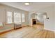 Living room with refinished hardwood floors, traditional radiator, and ample natural light at 2636 N Glencoe St, Denver, CO 80207