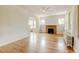 Spacious living room with refinished hardwood floors, a ceiling fan, and a fireplace at 2636 N Glencoe St, Denver, CO 80207