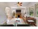 Bright living room with hardwood floors, a cozy fireplace, and ample natural light, perfect for entertaining at 2636 N Glencoe St, Denver, CO 80207