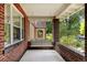 Inviting front porch features a comfortable swing, perfect for relaxing and enjoying the neighborhood views at 2636 N Glencoe St, Denver, CO 80207