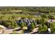 Stunning aerial view of a luxury home with a lake view surrounded by lush greenery and a picturesque neighborhood at 5470 S Highline Cir, Greenwood Village, CO 80121