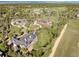 Wide aerial view of a home and grounds surrounded by mature trees and landscaping in a luxury community at 5470 S Highline Cir, Greenwood Village, CO 80121
