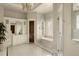 A luxurious bathroom featuring a soaking tub, marble finishes, a glass-enclosed shower, and custom cabinetry at 5470 S Highline Cir, Greenwood Village, CO 80121