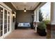 Cozy covered porch with porch swing, heater, and elegant columns perfect for relaxation at 5470 S Highline Cir, Greenwood Village, CO 80121