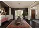 Sophisticated dining room featuring dark walls, statement rug, and access to an adjacent entryway with plenty of natural light at 5470 S Highline Cir, Greenwood Village, CO 80121