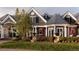 Beautiful home exterior with detailed architectural features, lush landscaping, and a well-kept lawn at 5470 S Highline Cir, Greenwood Village, CO 80121
