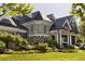 An elegant home with stone accents, manicured landscaping, and a turret-style window adds curb appeal at 5470 S Highline Cir, Greenwood Village, CO 80121