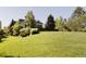 Well-manicured lawn surrounds a traditional home with trees and shrubbery at 5470 S Highline Cir, Greenwood Village, CO 80121