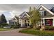 Beautiful home featuring a manicured lawn, and a covered front porch and stone accents add curb appeal at 5470 S Highline Cir, Greenwood Village, CO 80121