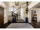 Grand foyer showcasing a curved staircase, elegant lighting, and beautiful hardwood floors provides an inviting ambiance at 5470 S Highline Cir, Greenwood Village, CO 80121