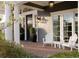 Inviting front porch featuring a seating area, stylish lighting, and manicured landscaping enhance curb appeal at 5470 S Highline Cir, Greenwood Village, CO 80121