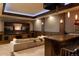 Luxurious home theater room featuring a large screen, projector, comfortable seating, and a bar area at 5470 S Highline Cir, Greenwood Village, CO 80121