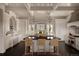 Bright kitchen with white cabinets, stainless steel appliances, gray island, and pendant lighting at 5470 S Highline Cir, Greenwood Village, CO 80121