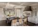 Modern kitchen featuring white cabinets, two islands, stainless steel appliances, and designer lighting fixtures at 5470 S Highline Cir, Greenwood Village, CO 80121