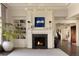 Elegant fireplace is flanked by custom built-ins in this stylish living room with hardwood floors at 5470 S Highline Cir, Greenwood Village, CO 80121