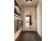 Elegant mud room featuring a geometric rug, coat rack, and a view to the pool outside at 5470 S Highline Cir, Greenwood Village, CO 80121