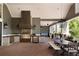 Spacious outdoor kitchen with brick patio, stainless steel grill, and ample seating for entertaining at 5470 S Highline Cir, Greenwood Village, CO 80121