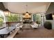Inviting outdoor living area with a fireplace, comfortable seating, and an elegant brick patio at 5470 S Highline Cir, Greenwood Village, CO 80121