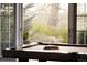 Close-up view of a pool table with a view of the garden through the window at 5470 S Highline Cir, Greenwood Village, CO 80121