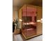 Modern sauna with glass door, wooden benches, and ambient lighting for relaxation and wellness at 5470 S Highline Cir, Greenwood Village, CO 80121