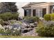 Lush water feature with surrounding stones and greenery sits in front of a home with dark shutters at 5470 S Highline Cir, Greenwood Village, CO 80121