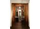 A sleek wine room encased in glass, showcasing custom shelving, a wine refrigerator, and a striking wood finish at 5470 S Highline Cir, Greenwood Village, CO 80121