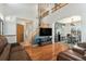 Open-concept living area with high ceilings, a wood staircase, and hardwood floors at 16651 Tree Haven St, Hudson, CO 80642