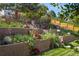 Multi-tiered backyard featuring decorative retaining walls, flowerbeds, and access stairs at 5425 Camargo Rd, Littleton, CO 80123