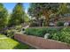 Multi-tiered backyard featuring decorative retaining walls, flowerbeds, and access stairs at 5425 Camargo Rd, Littleton, CO 80123