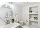 Bright and modern bathroom with new vanity and updated storage shelves at 5425 Camargo Rd, Littleton, CO 80123