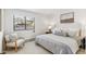 Serene bedroom featuring a plush bed, soft gray tones, and a sunlit window with views of the outside at 5425 Camargo Rd, Littleton, CO 80123