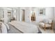 Bright bedroom with mirrored closet, comfortable chair, and adjacent bathroom at 5425 Camargo Rd, Littleton, CO 80123