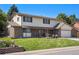 Charming two-story home featuring a lush lawn, well-maintained landscaping, and a welcoming entrance at 5425 Camargo Rd, Littleton, CO 80123