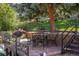 Cozy brick patio with wrought iron table and chairs nestled in landscaped backyard at 5425 Camargo Rd, Littleton, CO 80123