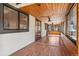 Bright sunroom with wood paneling, large windows, and a ceiling fan for year-round enjoyment at 5425 Camargo Rd, Littleton, CO 80123