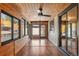 Charming sunroom featuring wood accents, ample windows, and a ceiling fan for comfortable indoor/outdoor living at 5425 Camargo Rd, Littleton, CO 80123