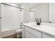 Bathroom with white subway tile, shower-tub combo, single sink, and modern fixtures at 2537 Lupton Ln, Lafayette, CO 80026