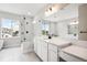 Bright bathroom featuring double sinks, sleek vanities, a glass-enclosed shower, and a window at 2537 Lupton Ln, Lafayette, CO 80026